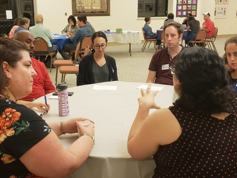 a group sitting around a table discussing