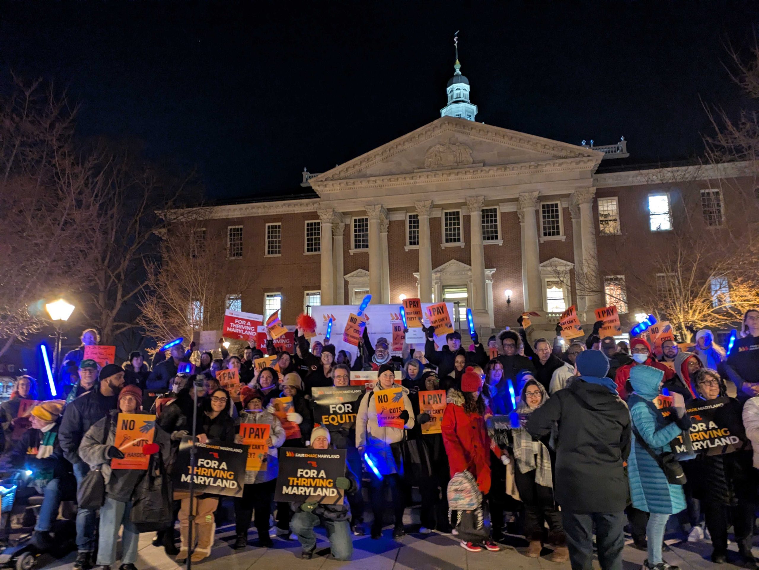 Immigrant justice rally outside the state capitol at night