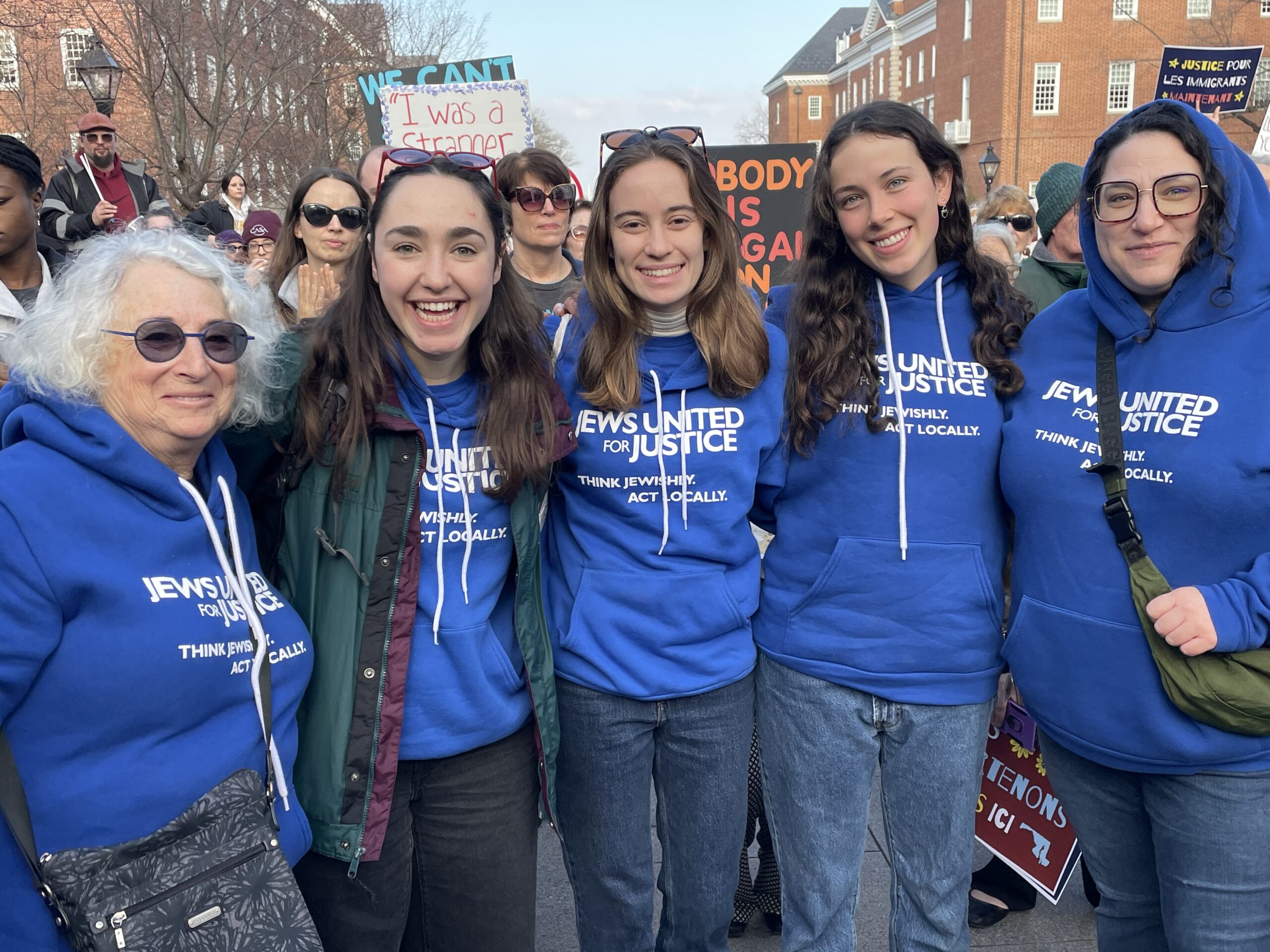JUFJ staff and leaders supporting justice at an immigrant justice rally -- and all wearing the same JUFJ sweatshirt!